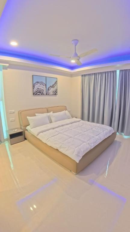 Presidential Suite bedroom featuring a king-size bed, elegant furnishings, bedside tables, and full-length curtains.