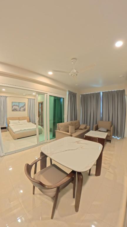 Deluxe One Bedroom Apartment featuring a comfortable bedroom, spacious living area, kitchenette, and modern interior.