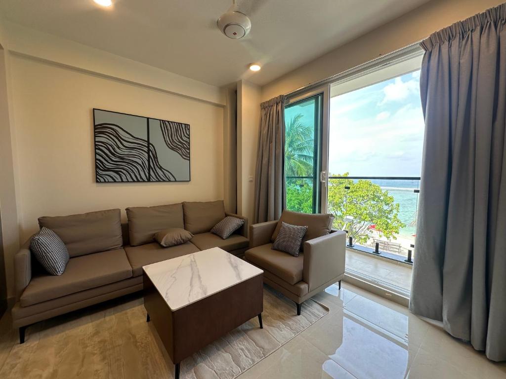 Beachfront living area with comfortable seating, elegant interiors, and stunning ocean views.