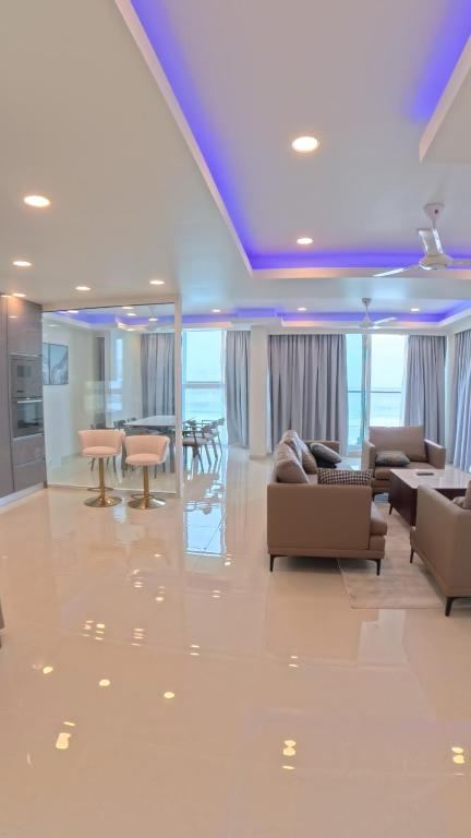 Presidential Suite living area featuring elegant seating, a dining area, modern interiors, and stunning ocean views.