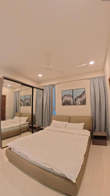 One Bedroom Apartment with a bedroom, living area, kitchenette, and modern interior.